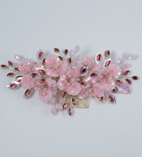 Decorative pink flower with gemstones on a white background